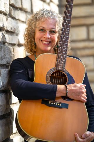 Jeanie B. Holding a Guitar