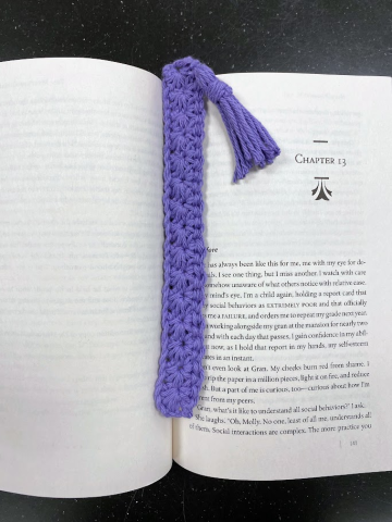 crochet purple bookmark in a book