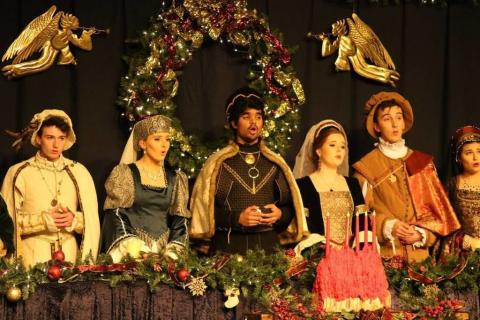 5 teenagers in Madrigal garb, singing.