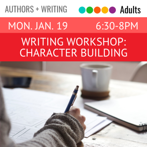 A person's hand is holding a pen and writing on paper. A notebook and a mug are also on the table.