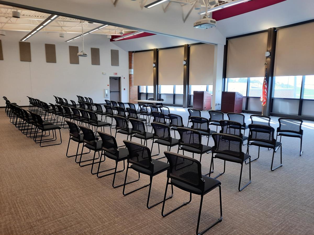 Room with multiple chairs and tables.