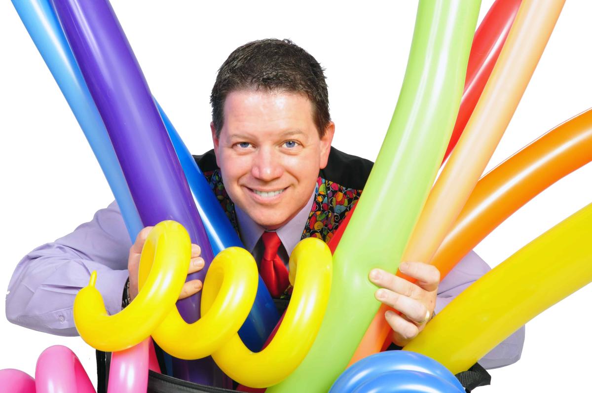 Dale Obrochta holding inflated balloons